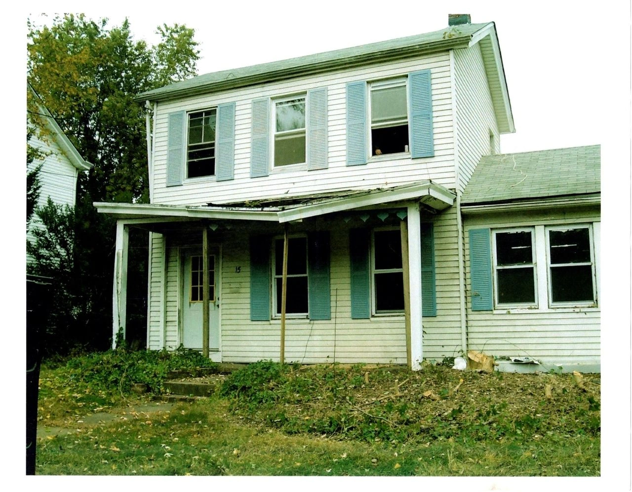 Old house with overgrown front yard