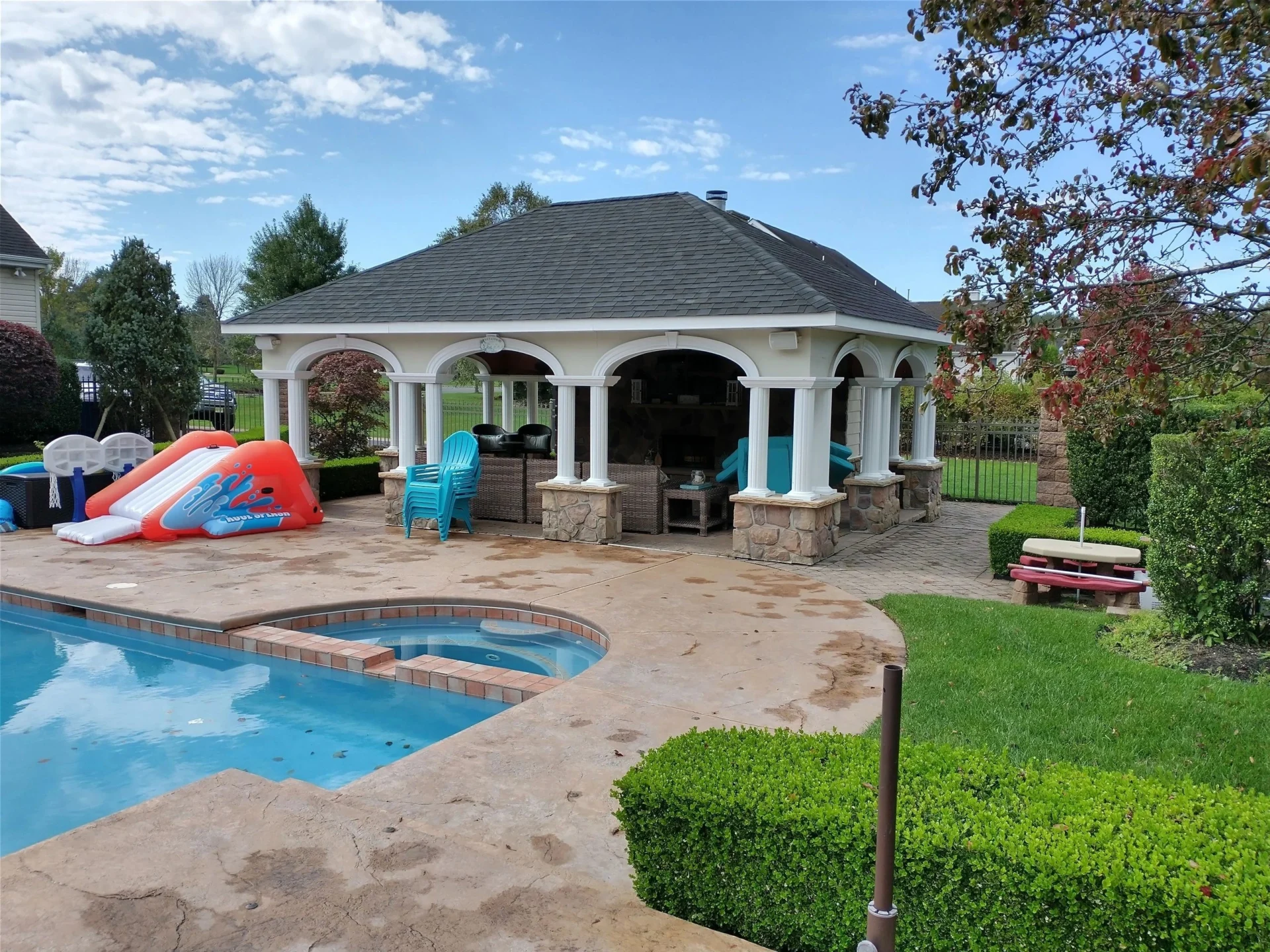 Outdoor pool and patio in garden setting